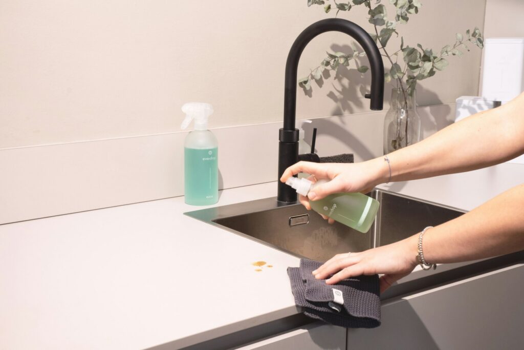 Cleaner wiping a kitchen sink during a deep cleaning in Lakeland, FL